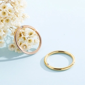 Macro detail of minimalist rose gold and gold rings with sparkling micro-inlaid diamonds
