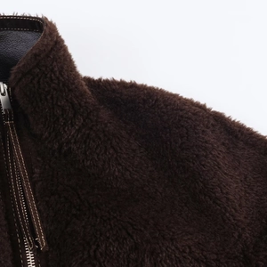 Women's brown faux fur jacket with high collar and leather trim detail