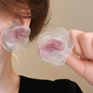 Detail of 3D layered organza flower earrings with pearls and purple gradient petals
