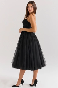 Detail of multi-layered black mesh fabric and pleated bodice on a backless evening dress