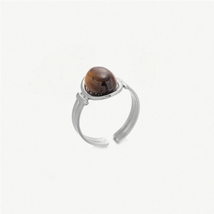 Close-up of vintage stainless steel ring with oval brown tiger eye stone and open band