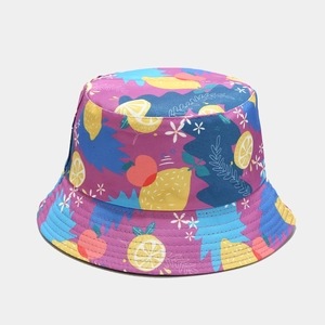Detailed close-up of summer bucket hat featuring vibrant lemon and peach floral patterns