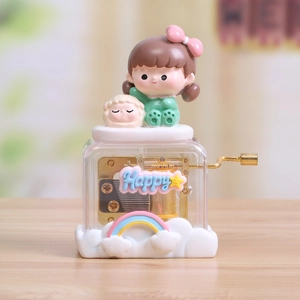 Gros plan sur boîte à musique à manivelle avec figurine de fille et mouton mignon