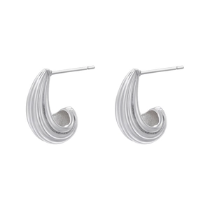Macro detail of silver drop earrings with refined vertical ribbed texture finish