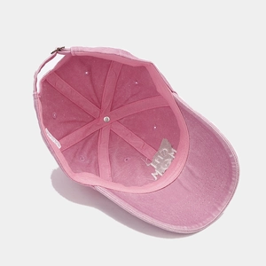Detail view of pink washed cotton baseball cap interior structure and metal strap buckle