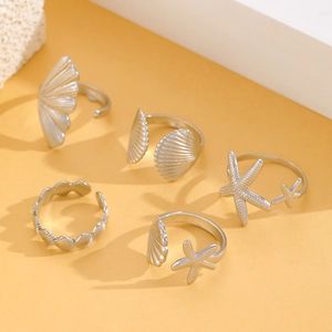 Detailed view of silver adjustable sea shell and starfish stainless steel rings