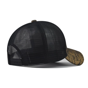 Detail of breathable black mesh trucker hat with tan brim and adjustable snapback closure