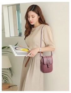 Detailed view of mauve lychee leather phone bag with multi-layer zippers and long strap