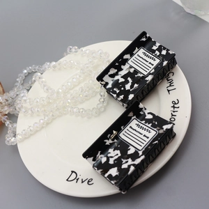 Set of two marble acetate hair claws with American composition book pattern design