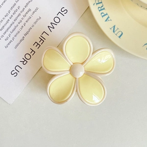 Floral hair claw clip in yellow and cream white finish with smooth resin texture
