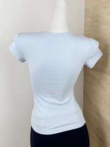 Detail view of the back of a light blue slim-fit ribbed T-shirt on a female mannequin