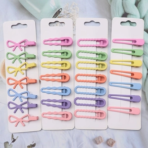 Colorful candy-colored geometric BB hair clips in various shapes on white cards