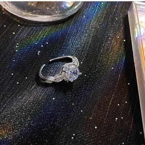 Macro shot of a silver adjustable ring featuring a large round zircon and leaf details