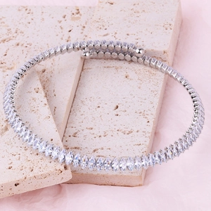 Silver choker necklace featuring marquise-cut crystals on textured stone background