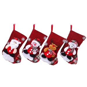 Set of four red Christmas stockings with Santa, snowman, reindeer, and polar bear figures