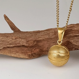 Macro shot of 24K gold plated basketball pendant featuring detailed surface texture