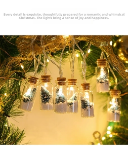 Close-up of LED glass wishing bottles with miniature snow-covered Christmas trees