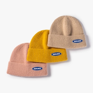 Set of thick ribbed knit beanies in pink, yellow and beige with orderliness logo patch