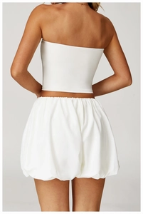 Back view of a white bubble skirt showing high-waisted gathered texture and puffy hem