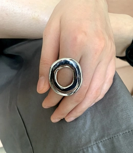 Detail of silver oversized irregular ring with organic texture on hand model