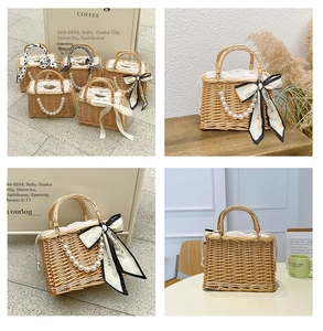 Detailed close-up of handmade straw bag featuring pearl handle and silk bow accents