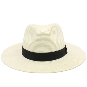 Close-up of the woven cream straw texture and black ribbon detail on the sun hat