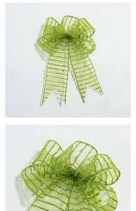 Detailed macro view of light green striped glitter bow ribbon for Christmas tree decoration