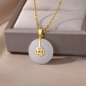 Detail of clover necklace with translucent white jade pendant and gold coin inlay