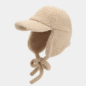 Close-up of beige fleece ear flap baseball cap showing thick thermal sherpa texture