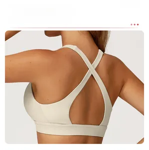 Detail of the criss-cross back design on a beige sports bra for yoga and fitness