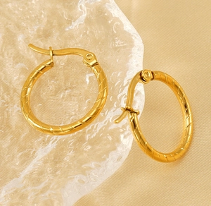 Close-up of 18K gold plated hoop earrings with detailed spiral rope texture and clasp