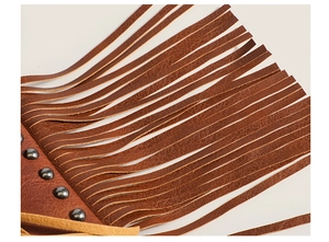 Macro detail of brown litchi pattern leather fringe with vintage metal rivet studs