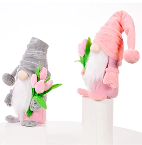 Close-up of plush Mother's Day gnomes with tulips on white display stands