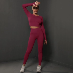 Detailed close-up of seamless burgundy yoga set with thumb holes and ribbed texture details