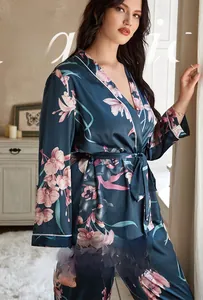Detail of navy blue floral satin pajama set with elegant white piping and waist tie belt