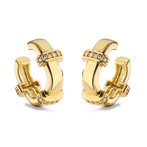 Close-up of golden hoop earrings featuring a buckle design with sparkling zircon stones