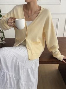 Women's yellow V-neck knit cardigan with front buttons and pockets for casual autumn wear