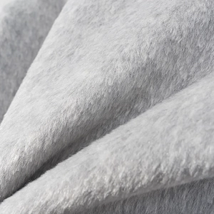 Close-up of soft grey faux fur texture on the collar of a winter padded jacket