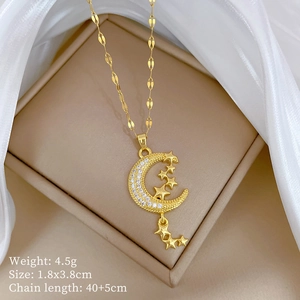 Detail of gold star moon pendant necklace with size specs on white silk background