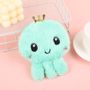 Detail of mint green plush octopus coin purse with crown and soft embroidery details