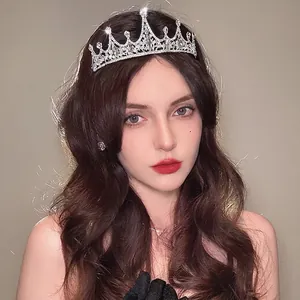 Elegant silver rhinestone tiara crown for weddings or birthdays worn by a model