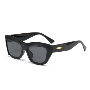 Retro cat-eye geometric sunglasses in glossy black with golden metal temple accents