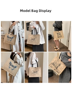 Detail view of large linen tote bags with various artistic prints and black tube handles
