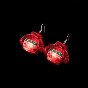 Glowing red Christmas sweater earrings with LED light and festive holiday patterns