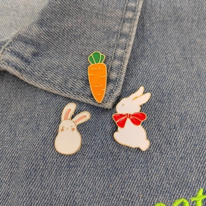 Cute white bunny and carrot enamel brooch pins set on denim jacket collar