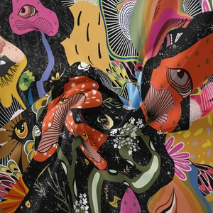 Close-up of bohemian tapestry showing trippy mushroom and floral patterns on black fabric