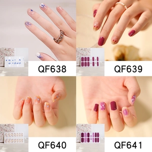 Macro display of four floral nail sticker designs in blue, wine red, orange, and purple hues