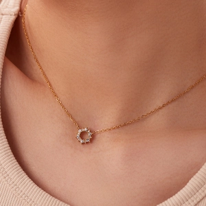 Elegant 18K gold necklace featuring irregular white zircon pendants on a female model