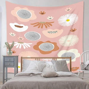 Detail view of Bohemian floral tapestry with pink daisy patterns over a cozy bed