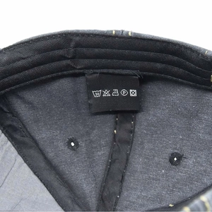 Detailed view of the 100% cotton fabric label with washing instructions inside the cap